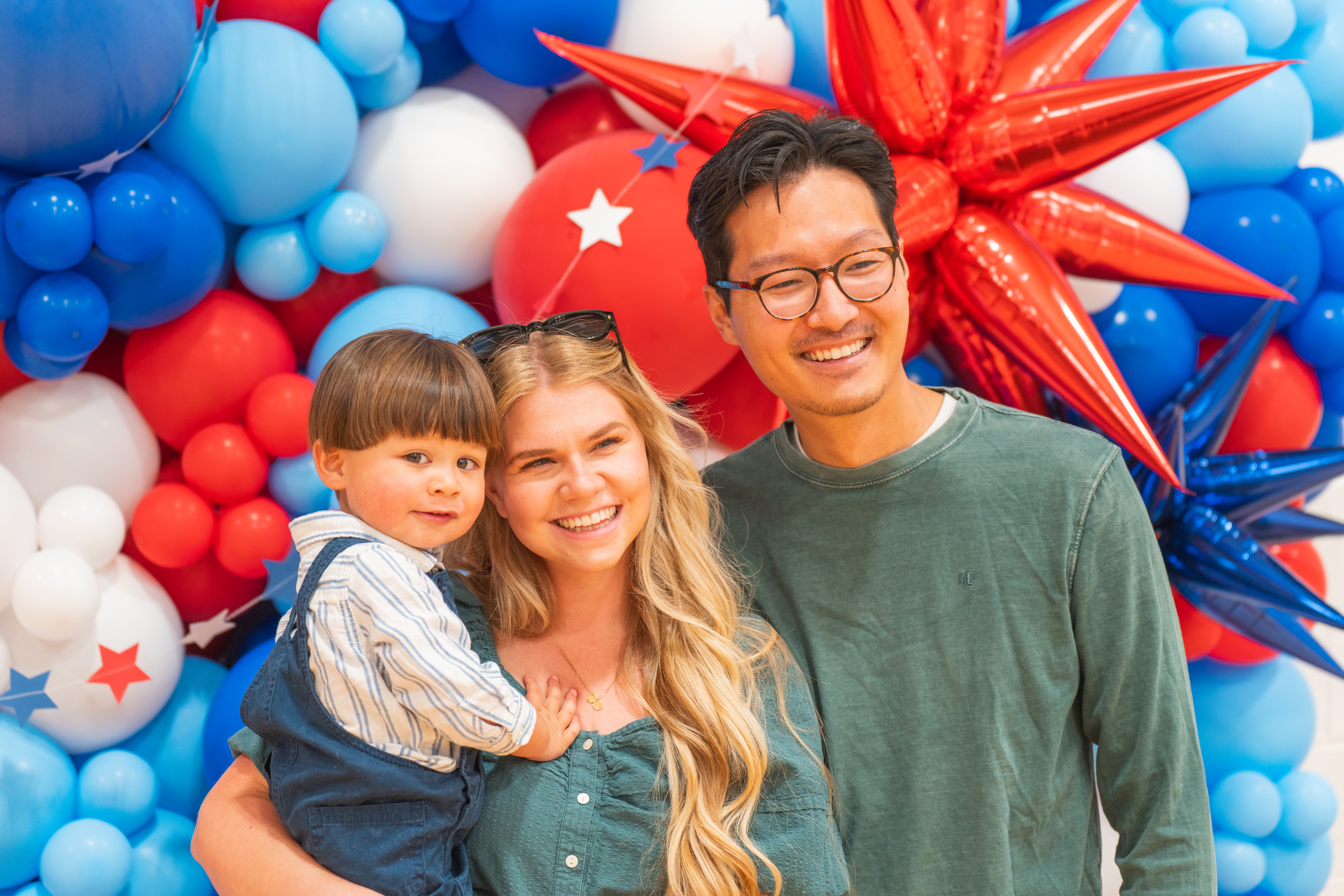Happy family smiling with a baby.